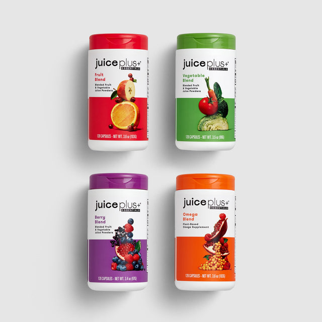 Four Juice Plus+ Essentials Capsules supplement on a white background