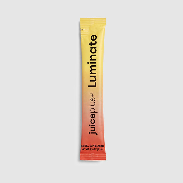 Juice Plus+ Luminate supplement packet on a light gray background