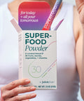 Box of Juice Plus+ Superfood Powder held by a person