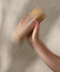 Person holding a shake against a neutral background