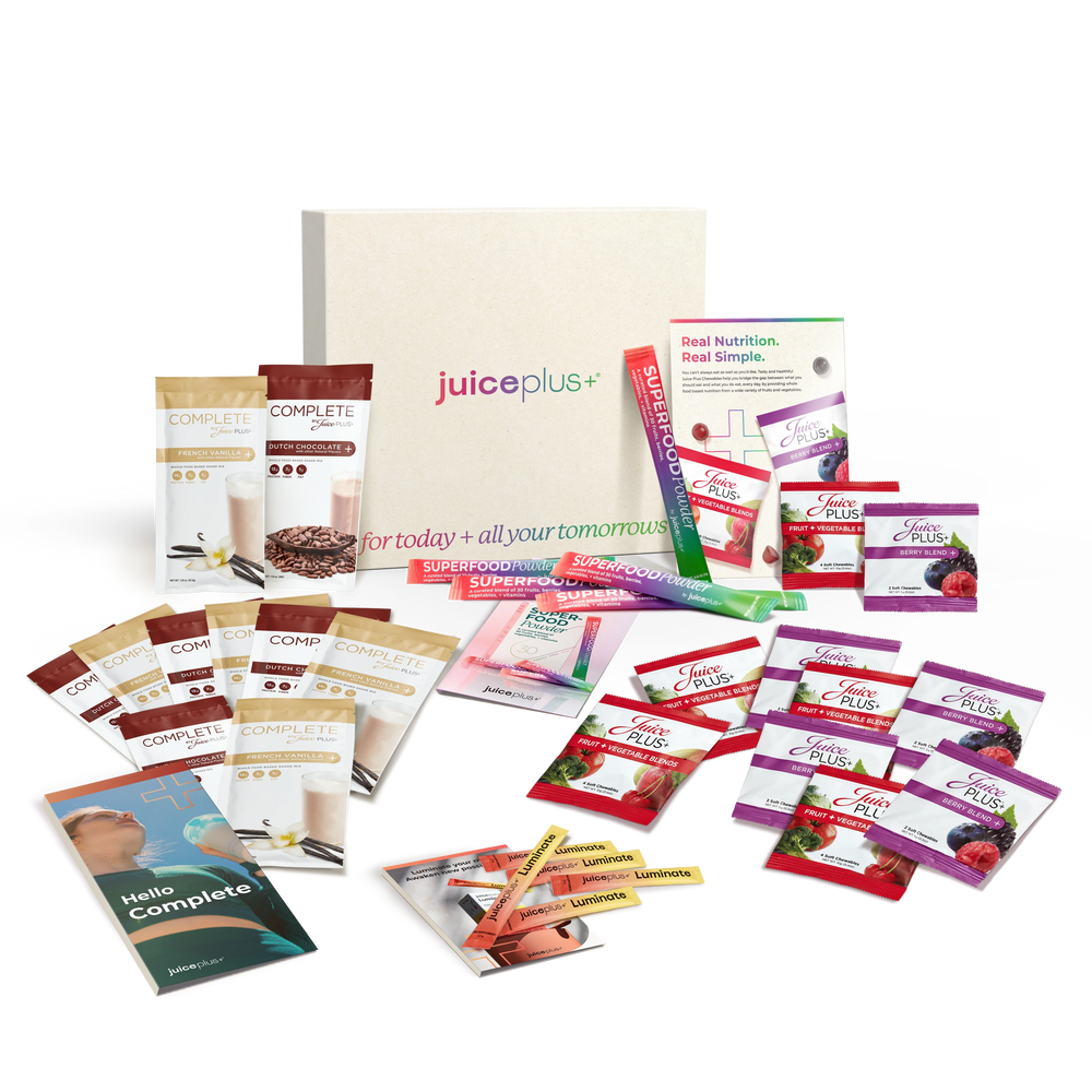 Collection of Juice Plus+ products including packets and boxes on a white background