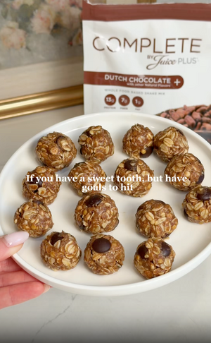 Plate of chocolate energy balls with a package of Juice Plus+ in the background