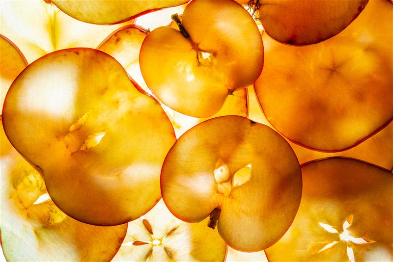 Close-up of translucent orange slices with a blurred background